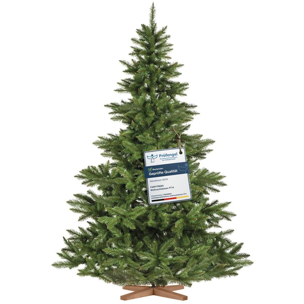 A green artificial Christmas tree with a wooden stand, featuring a tag with product information.