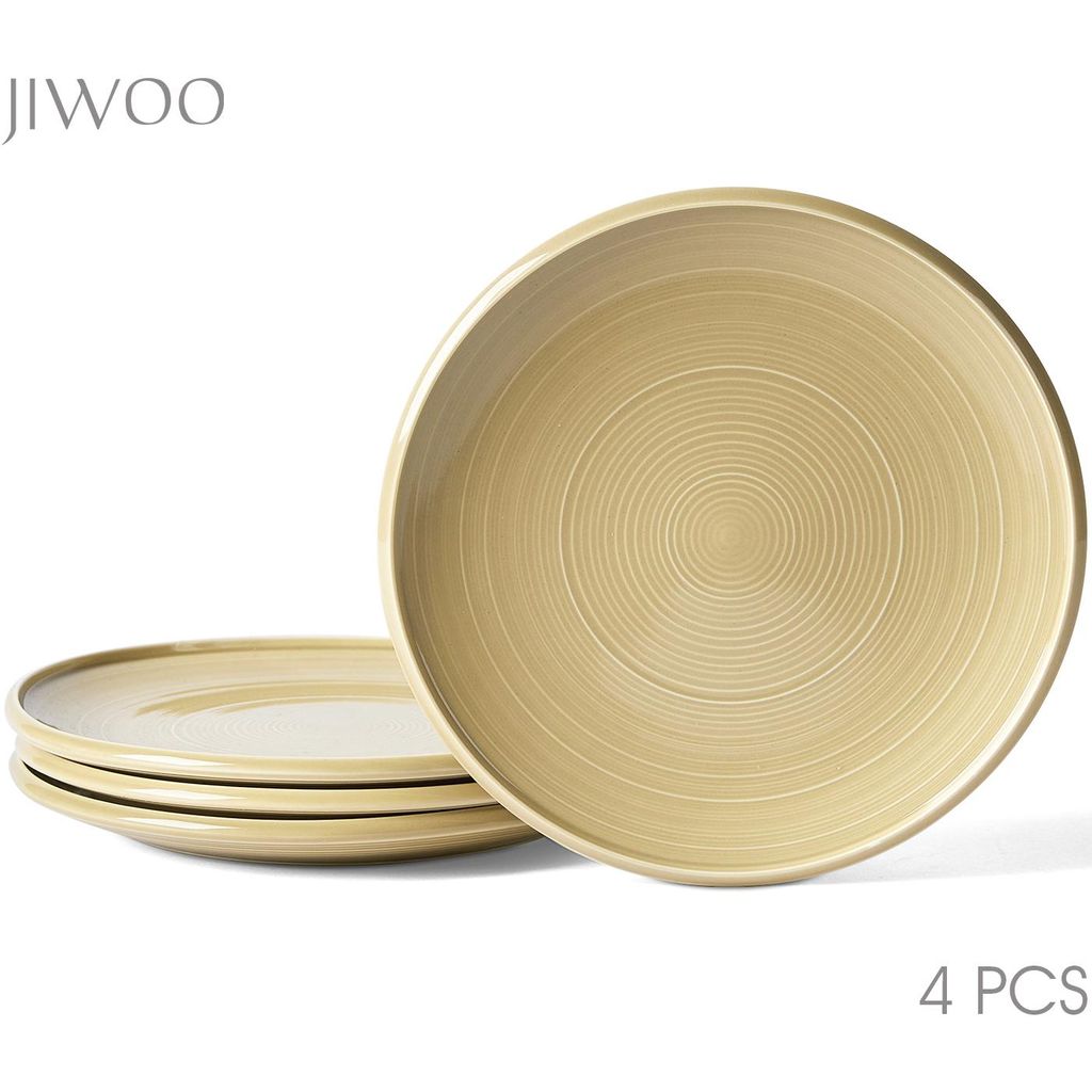 A set of four plates stacked, with one plate in the foreground showing its textured surface.
