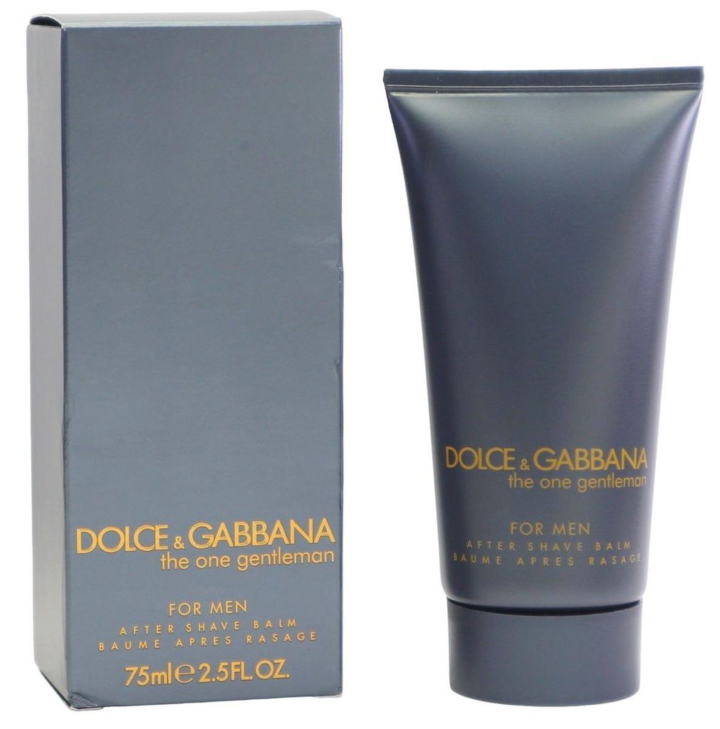 Dolce & Gabbana The One Gentleman After Shave Balm in dunkelgrauer Tube mit goldener Schrift, stehend neben passender Verpackung