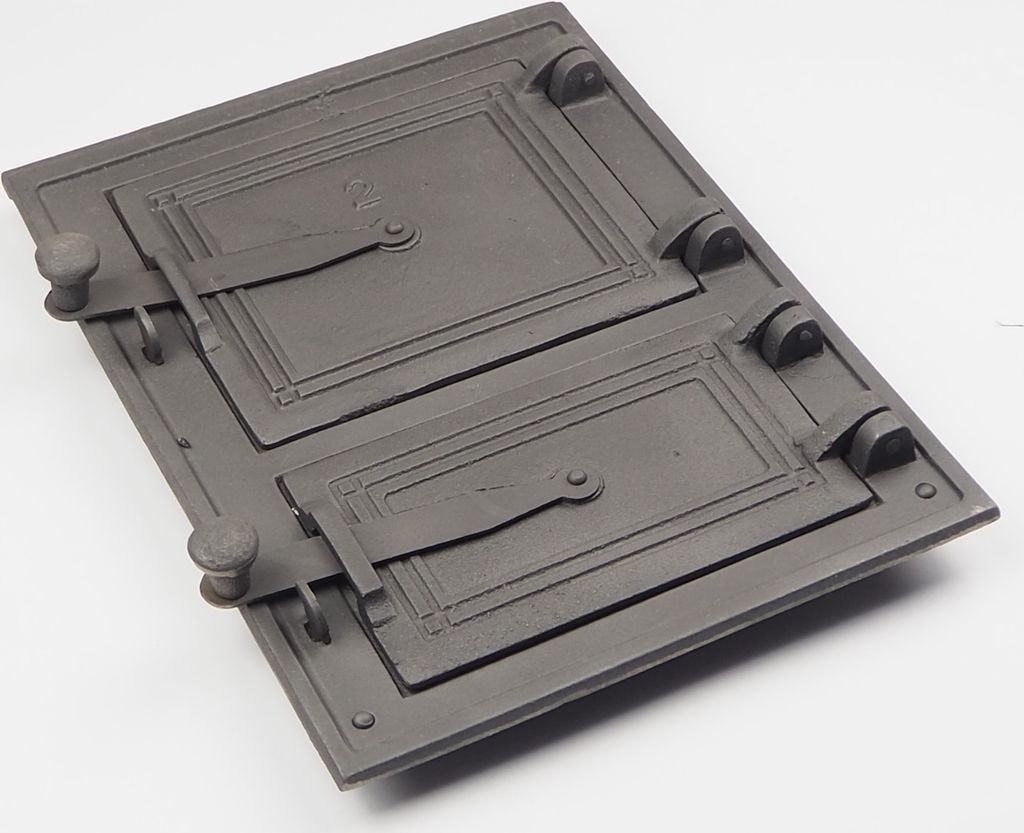 A cast iron oven door with two compartments, presented on a white background.