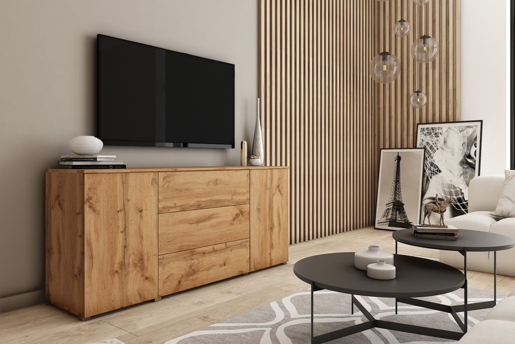 A modern living room with a TV, a wooden sideboard, coffee tables, and artwork.