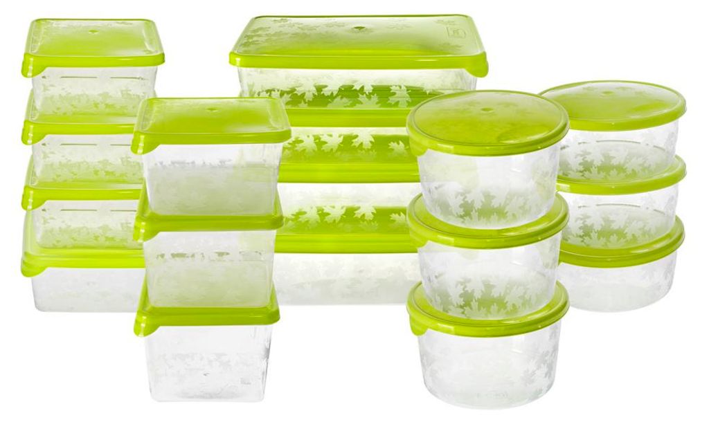 A collection of clear plastic food storage containers with green lids, arranged in groups.
