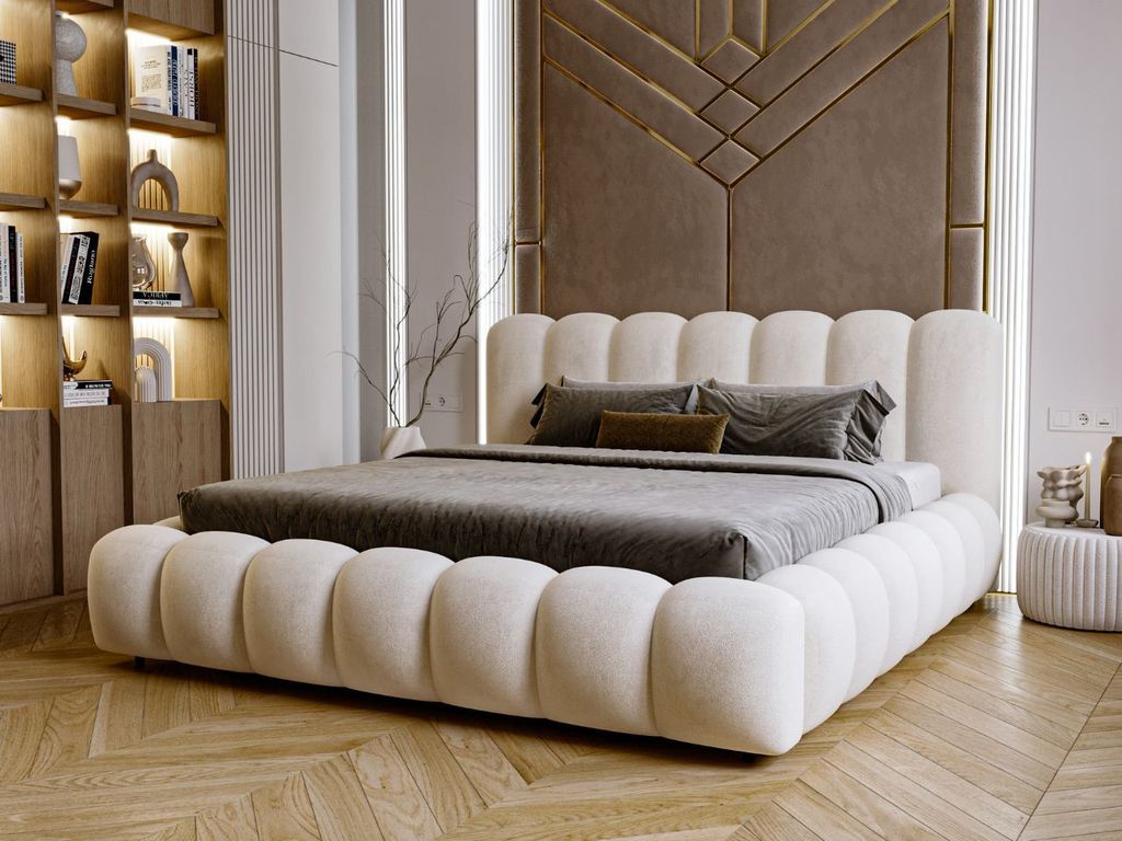 A modern bedroom with a large, upholstered bed as the focal point.