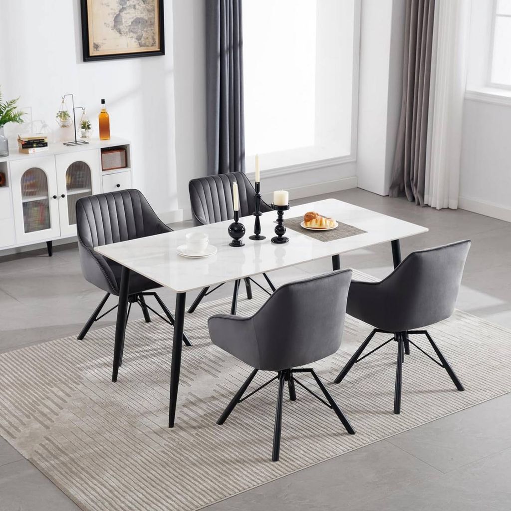 A dining room scene with a table and chairs.