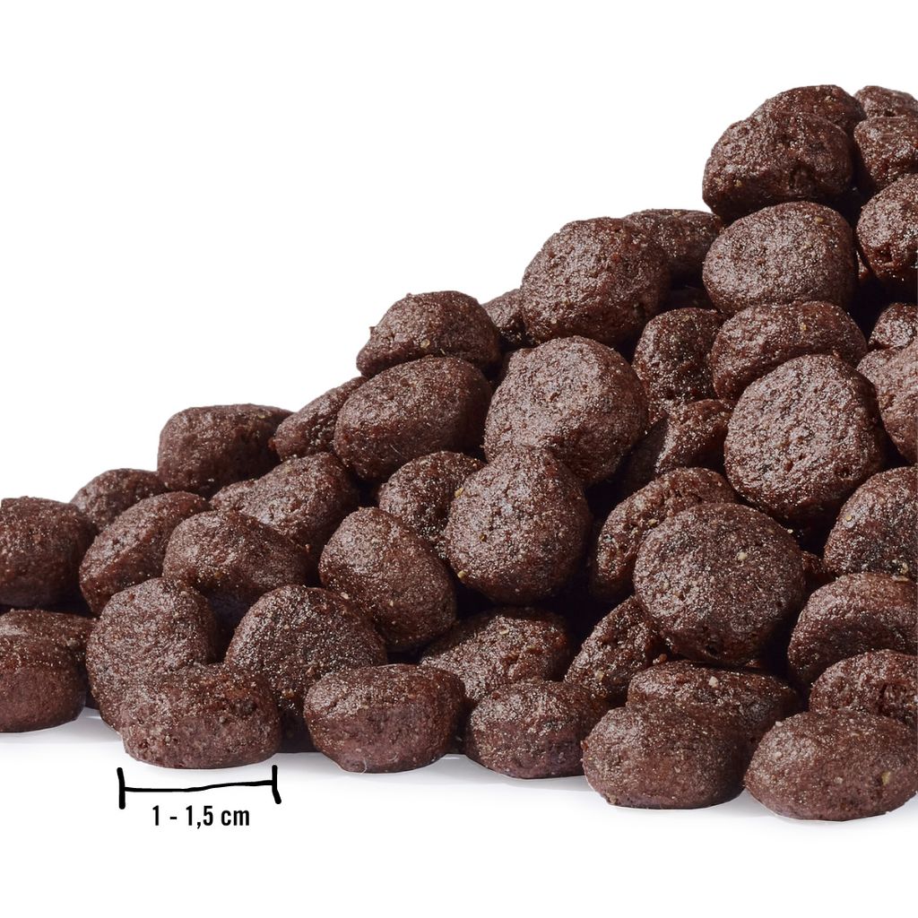 A pile of brown, round dog food kibble is shown against a white background.