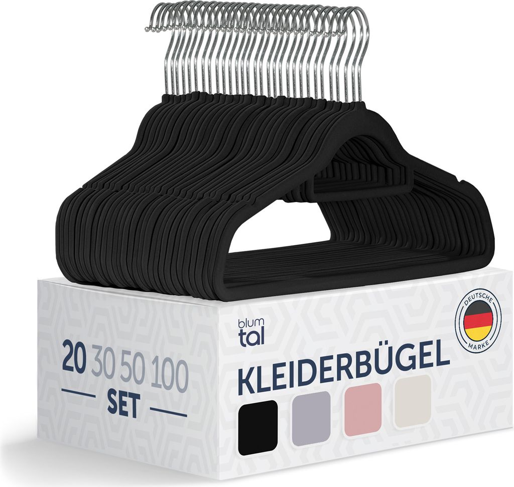 A stack of black velvet hangers on top of a product box.