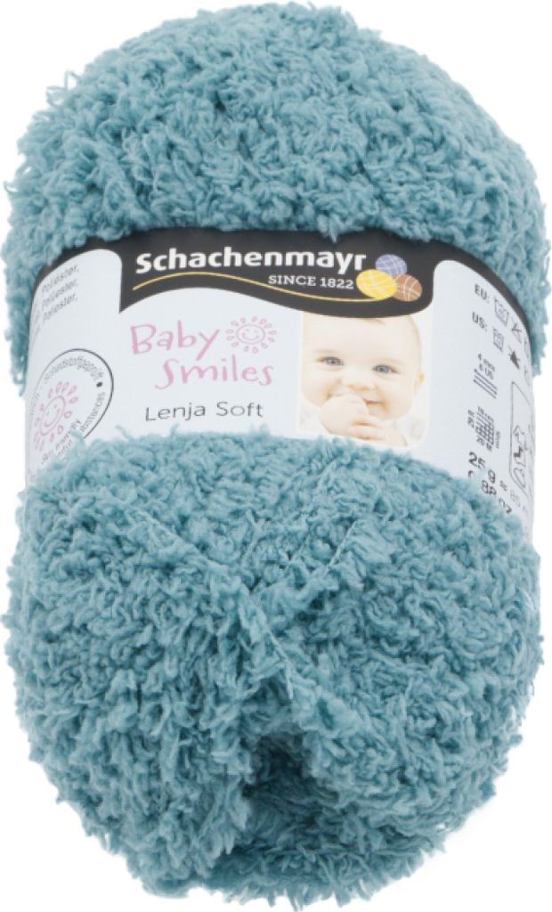 A ball of teal yarn with a label showing brand and product information, including a picture of a baby.