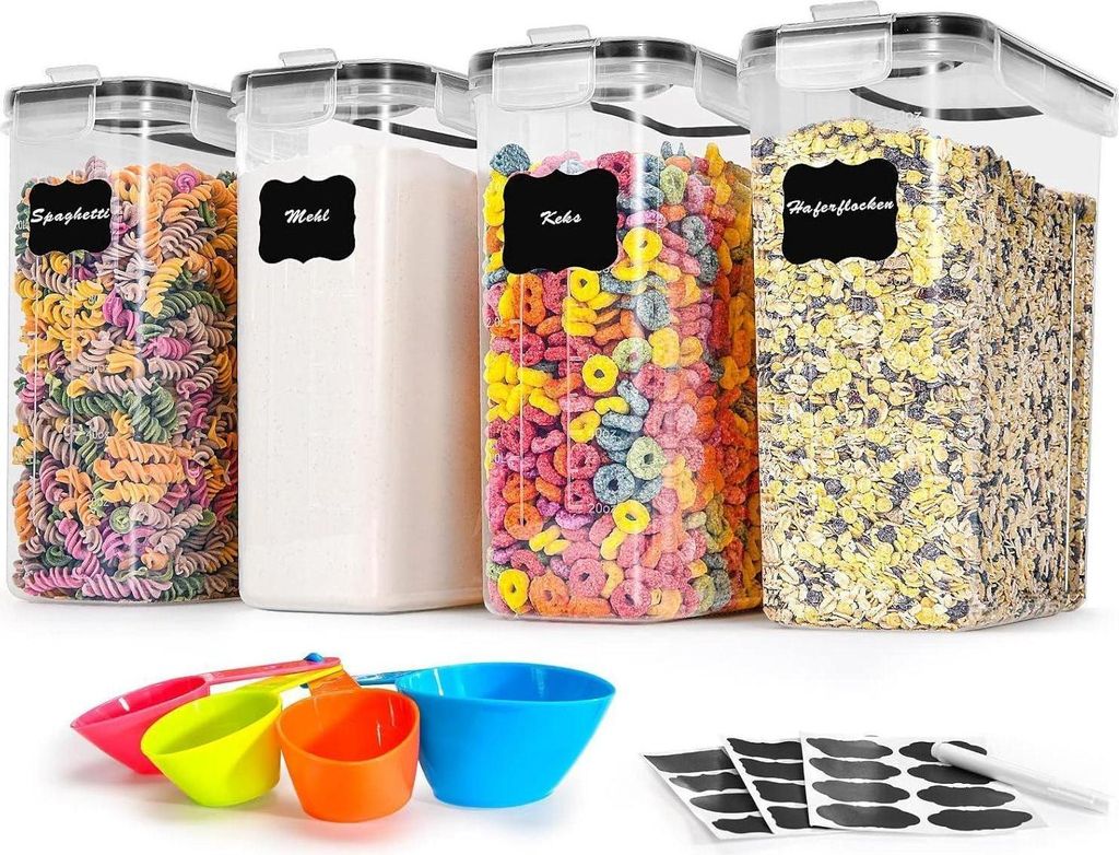 A set of four clear plastic food storage containers filled with different dry goods, along with measuring cups and labels.