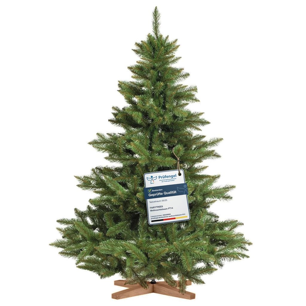 A green artificial Christmas tree with a wooden stand, featuring a tag with product information.