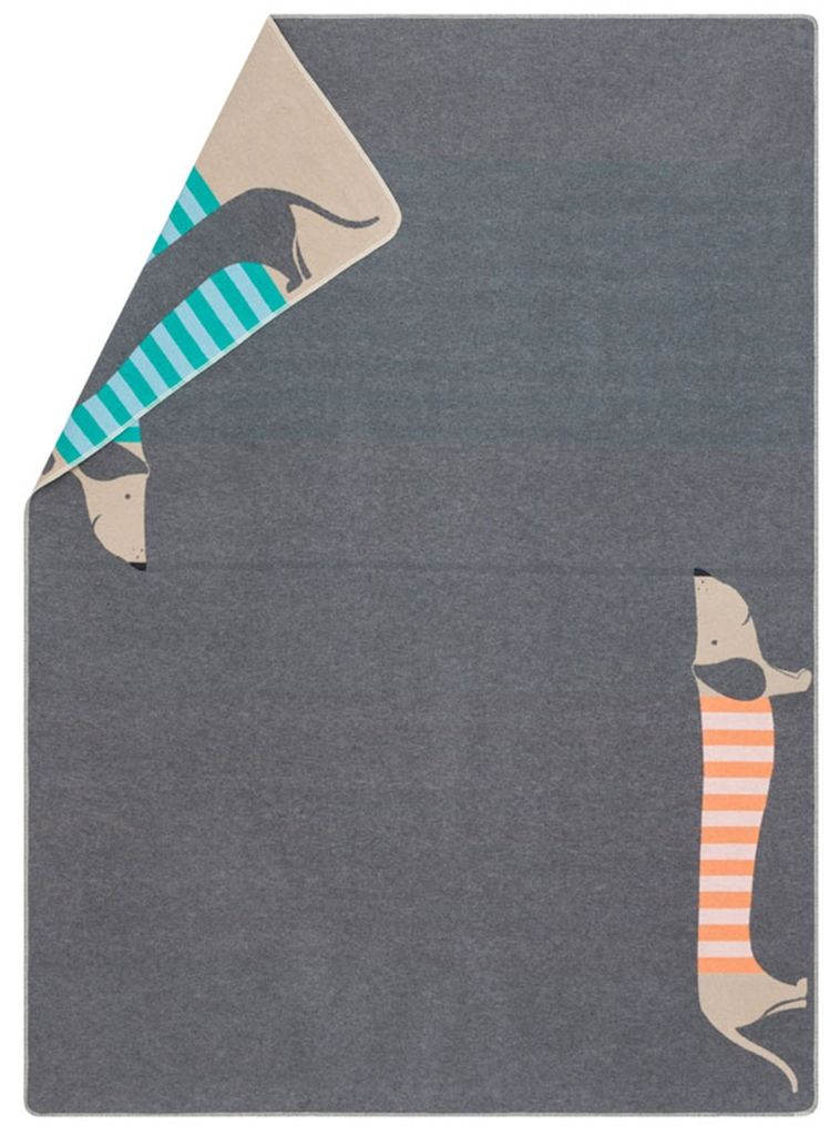 A folded blanket with a dachshund pattern on a gray background.