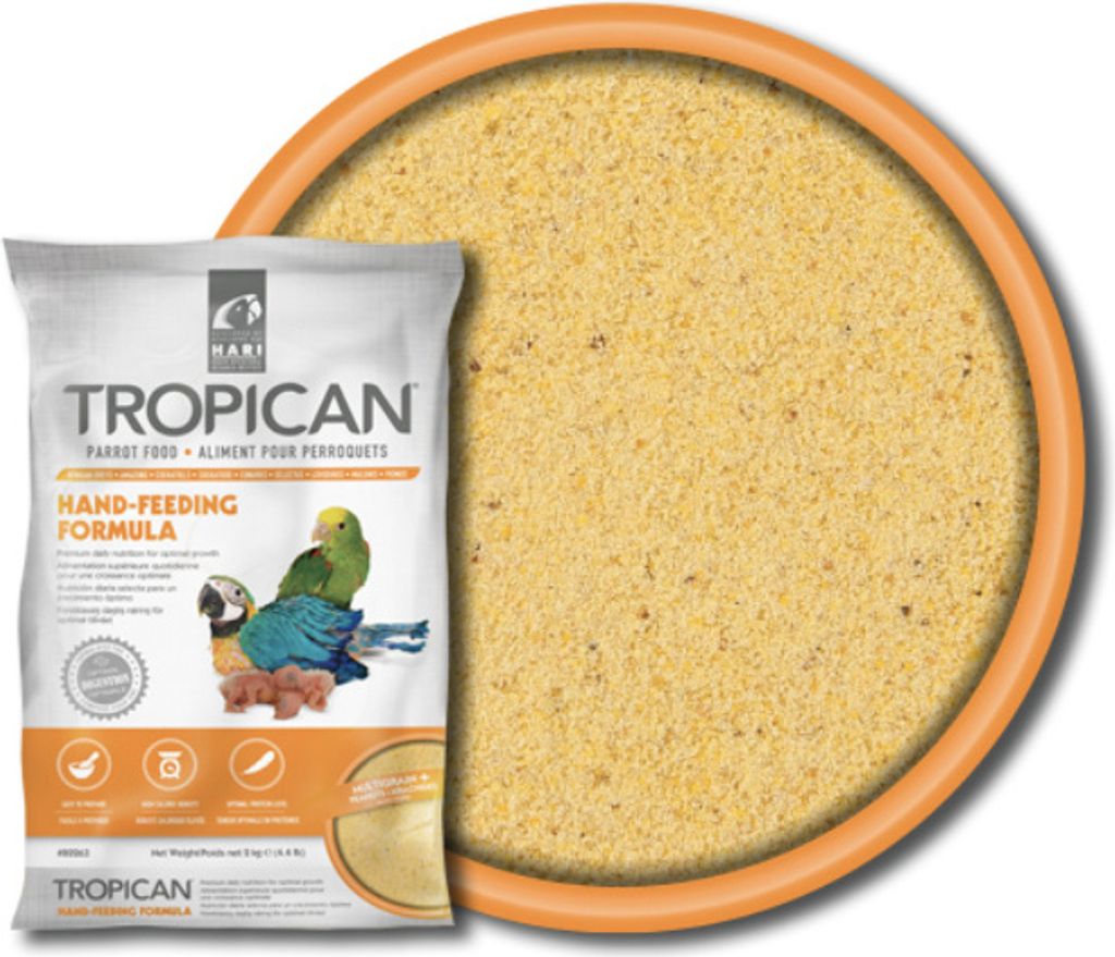 A bag of Tropican Hand Feeding Formula is shown next to a bowl filled with the product.
