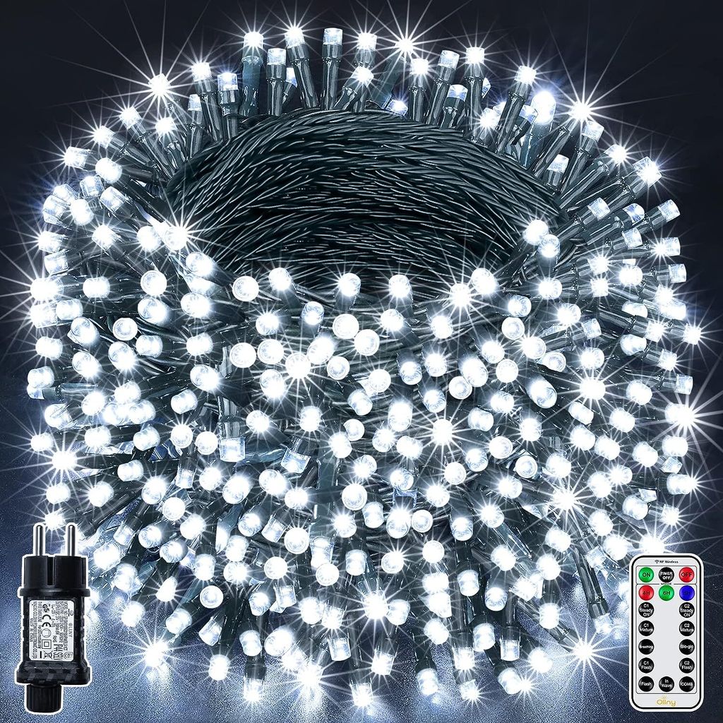 A bundle of white LED string lights coiled together, with a power adapter and a remote control visible.