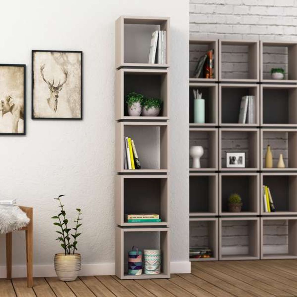 A modern living room with a tall, narrow bookshelf unit filled with books and decorative items, next to a wall with framed artwork.
