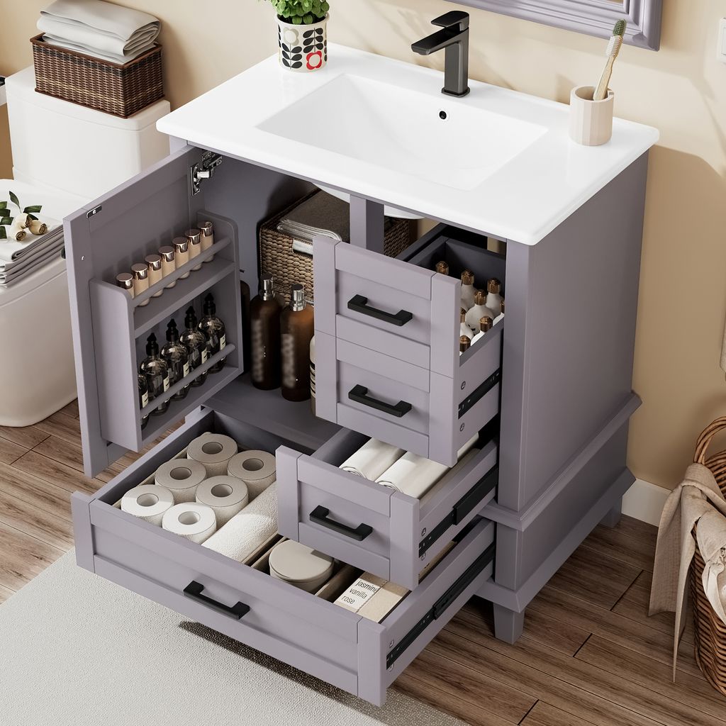 A bathroom vanity with the doors and drawers open, showing storage compartments.