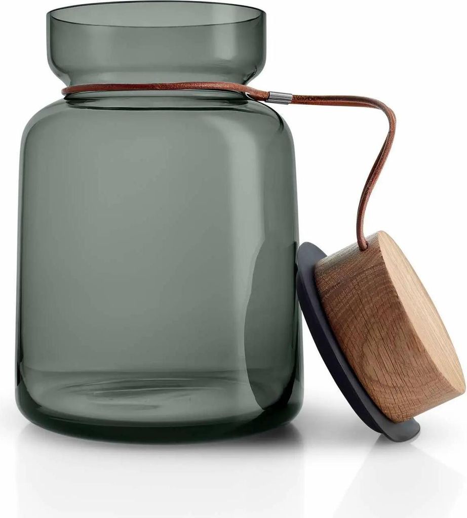 A glass storage jar with a wooden lid and leather strap.