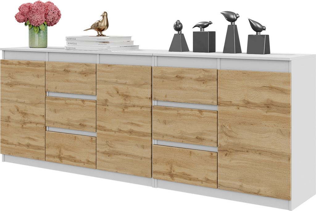 A white and wood grain sideboard with decorative bird figurines and a vase of flowers on top.
