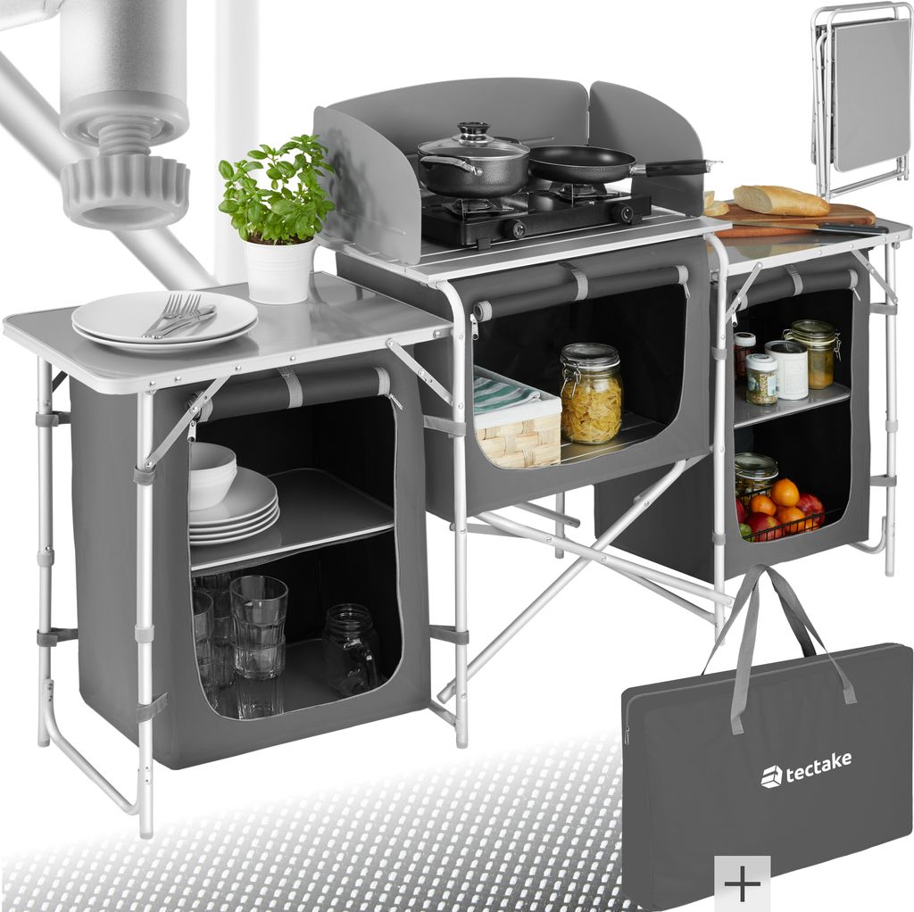 A camping kitchen setup with a stove, storage compartments, and accessories.