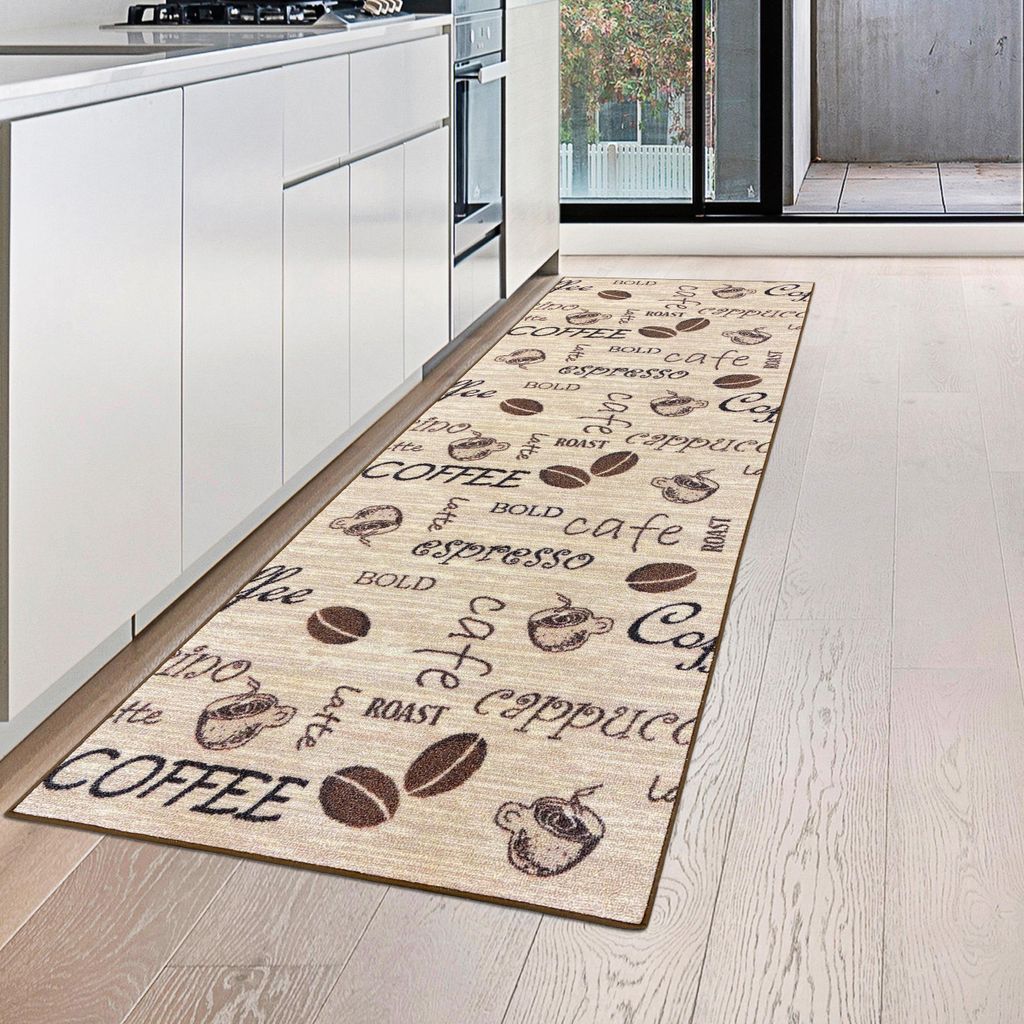 A kitchen runner rug with coffee-themed patterns is placed on a light wooden floor next to white kitchen cabinets.