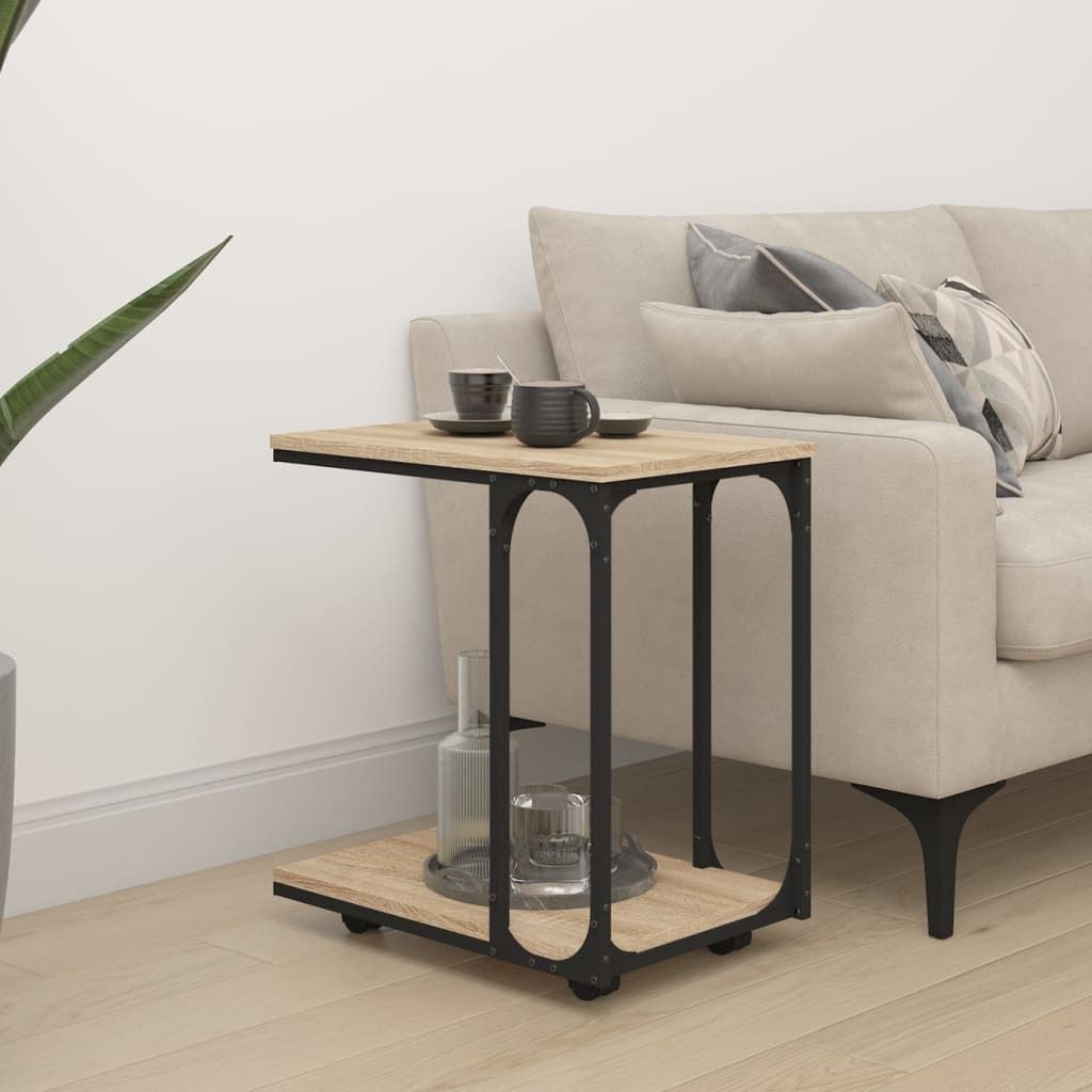 A C-table sits next to a sofa with two mugs on top and a bottle of water and a glass on the bottom shelf.