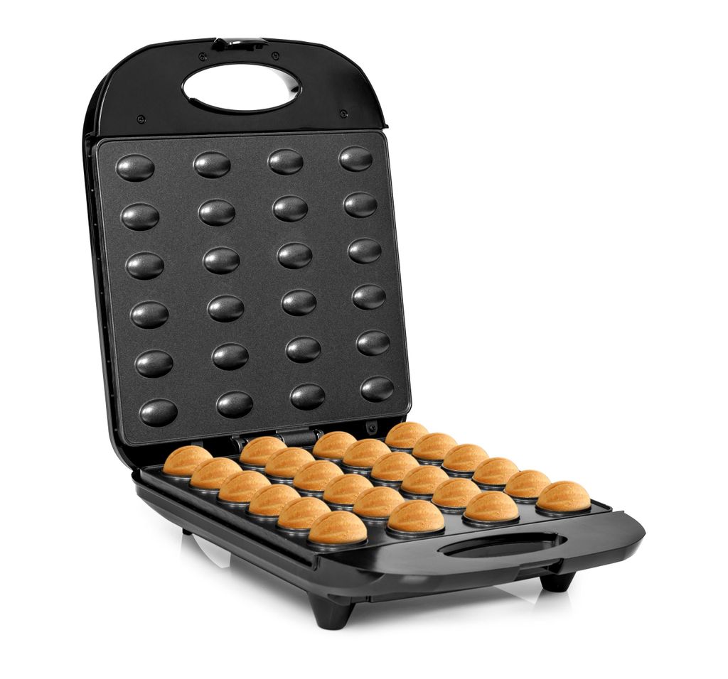 An open waffle maker with freshly baked waffle halves inside.
