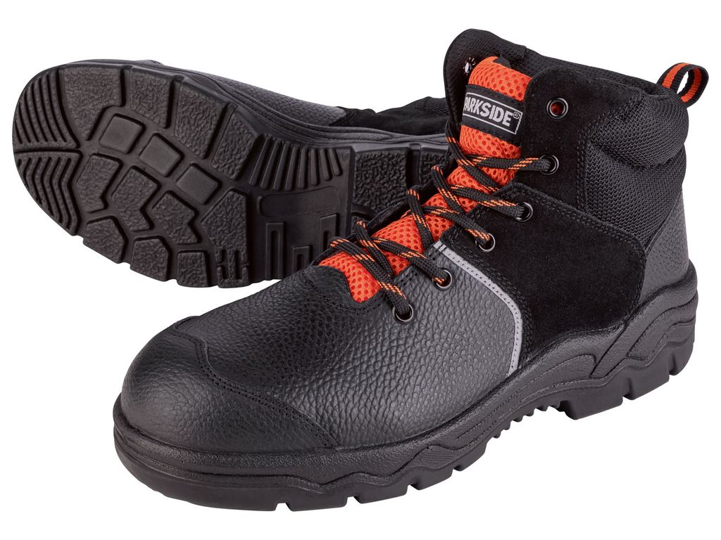A pair of black and orange work boots shown from a slightly elevated angle against a white background.