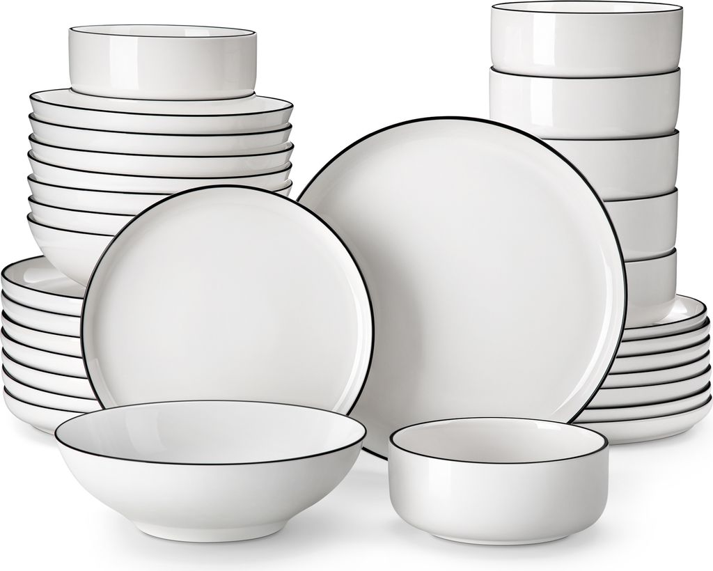 A collection of white ceramic plates and bowls with a thin black rim.