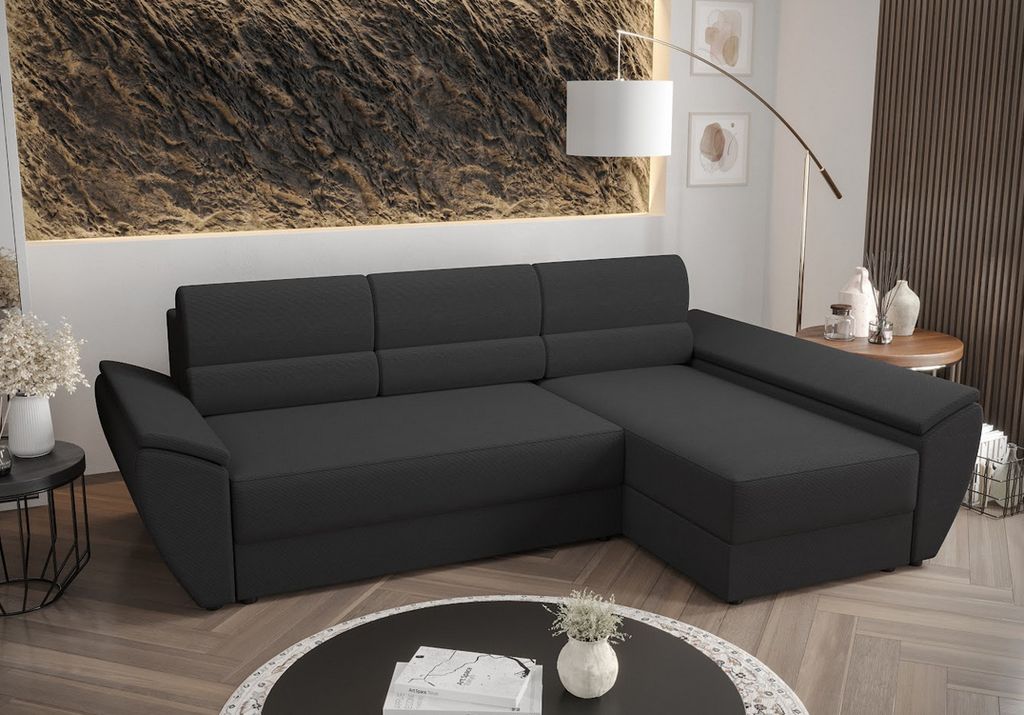 A dark gray sectional sofa is shown in a modern living room setting.