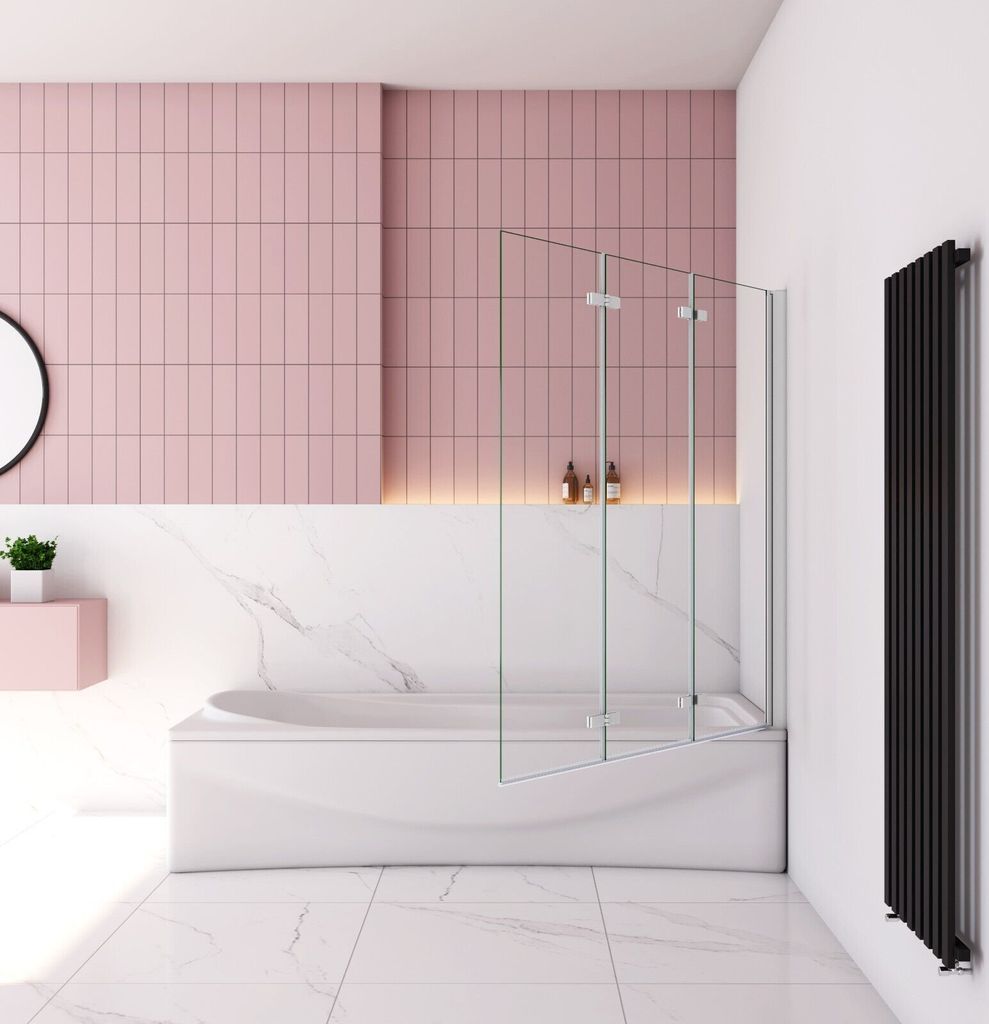 A modern bathroom featuring a bathtub with a glass shower screen, pink tiled walls, and marble accents.