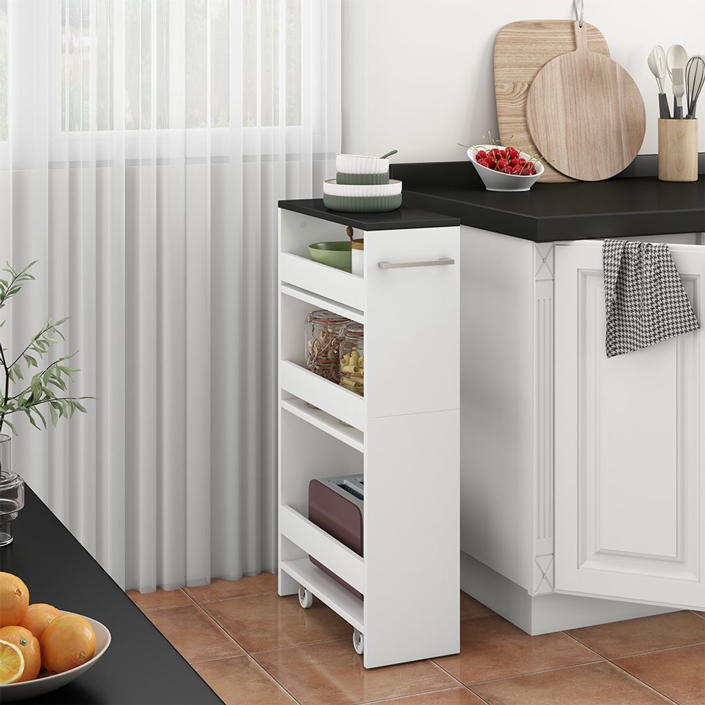 A narrow white roll-out shelf unit with black top is shown next to a white kitchen cabinet. The unit has three shelves, with items on the top two shelves. The top shelf has a green bowl and stacked white bowls. The second shelf has jars of food. The third 
