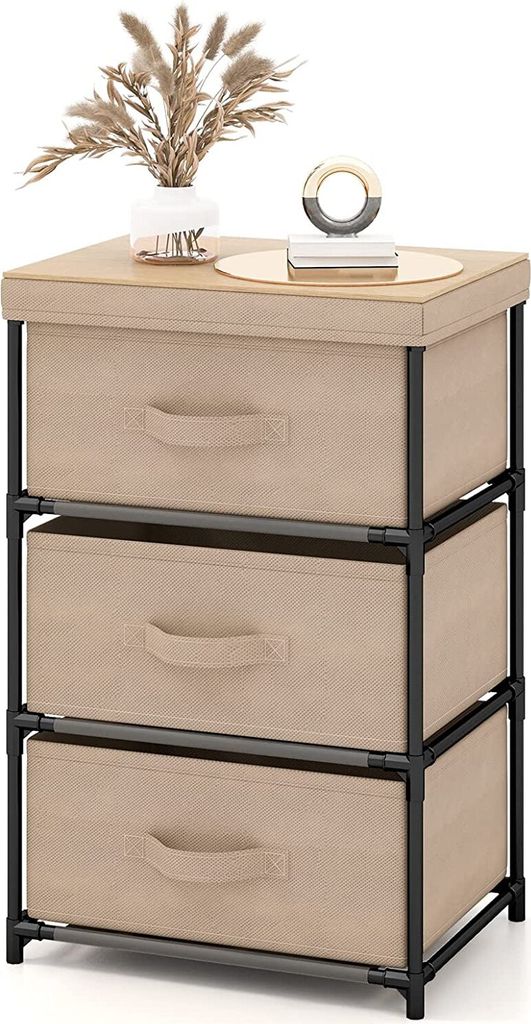 A three-drawer fabric dresser with a metal frame, topped with a decorative vase of dried flowers and a small decorative object.