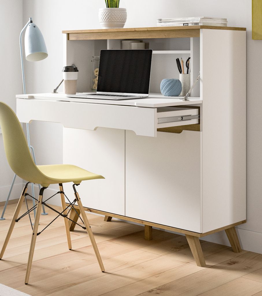 A modern white and wood secretary desk with a laptop, coffee cup, and office supplies on top, next to a yellow chair.