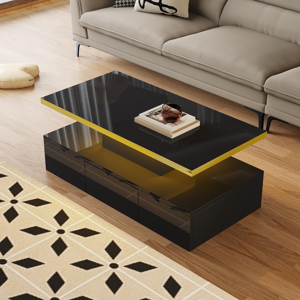A modern coffee table with a glossy black top and yellow accents sits on a wooden floor next to a couch.