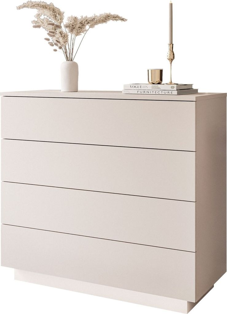 A minimalist dresser with decorative items on top.