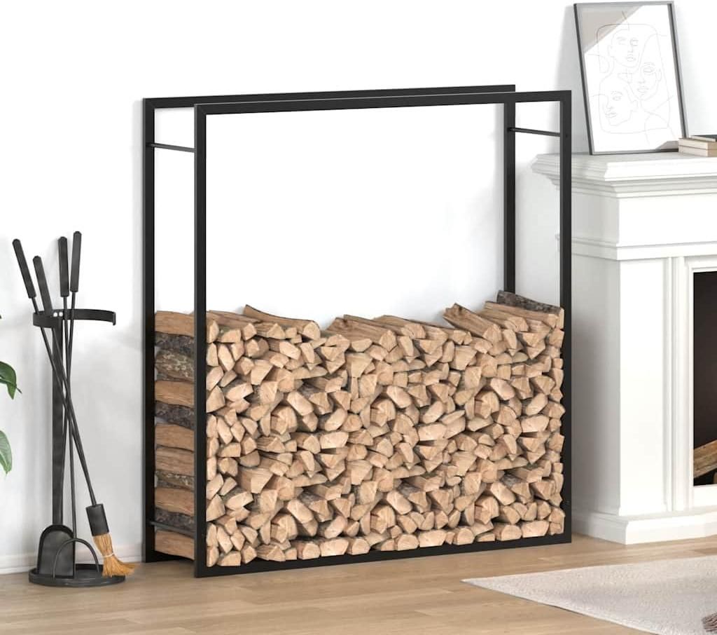 A black metal firewood rack filled with logs, placed next to a fireplace and fireplace tools.