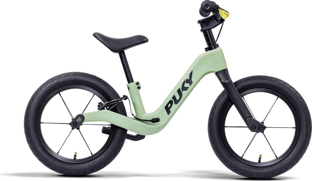 A light green balance bike with black wheels and seat is shown against a white background.