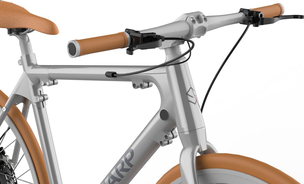 Close-up view of the handlebars, frame, and front wheel of a silver bicycle with brown accents.