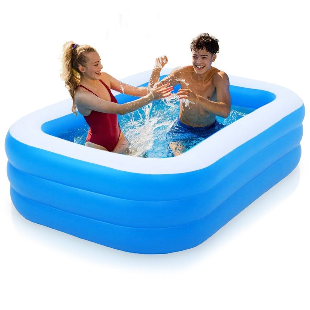 Two young people are splashing water in an inflatable swimming pool.
