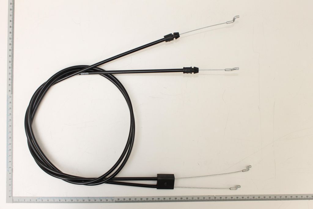 A set of two black Bowden cables with silver metal ends, laid out on a white background with a ruler along the bottom edge.