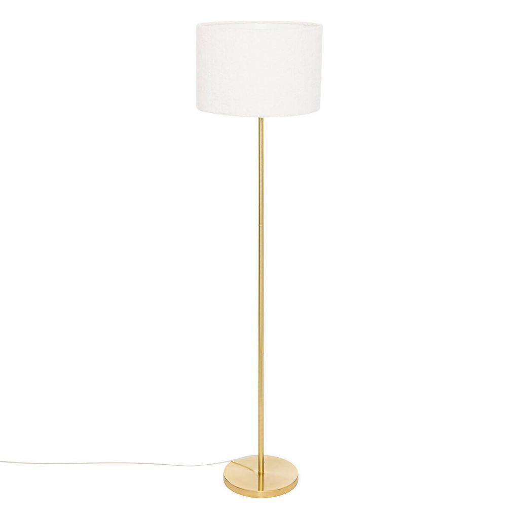 A floor lamp with a gold base and stem, and a white cylindrical lampshade, isolated on a white background.