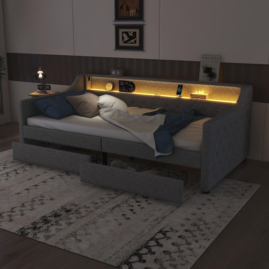 A modern daybed with integrated LED lighting and storage drawers, set in a bedroom environment.