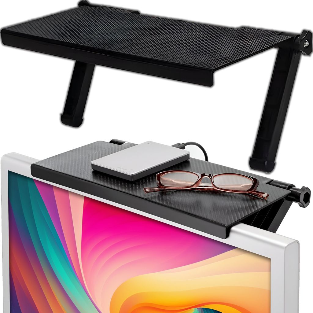 A black shelf sits on top of a computer monitor, holding a hard drive and a pair of glasses.