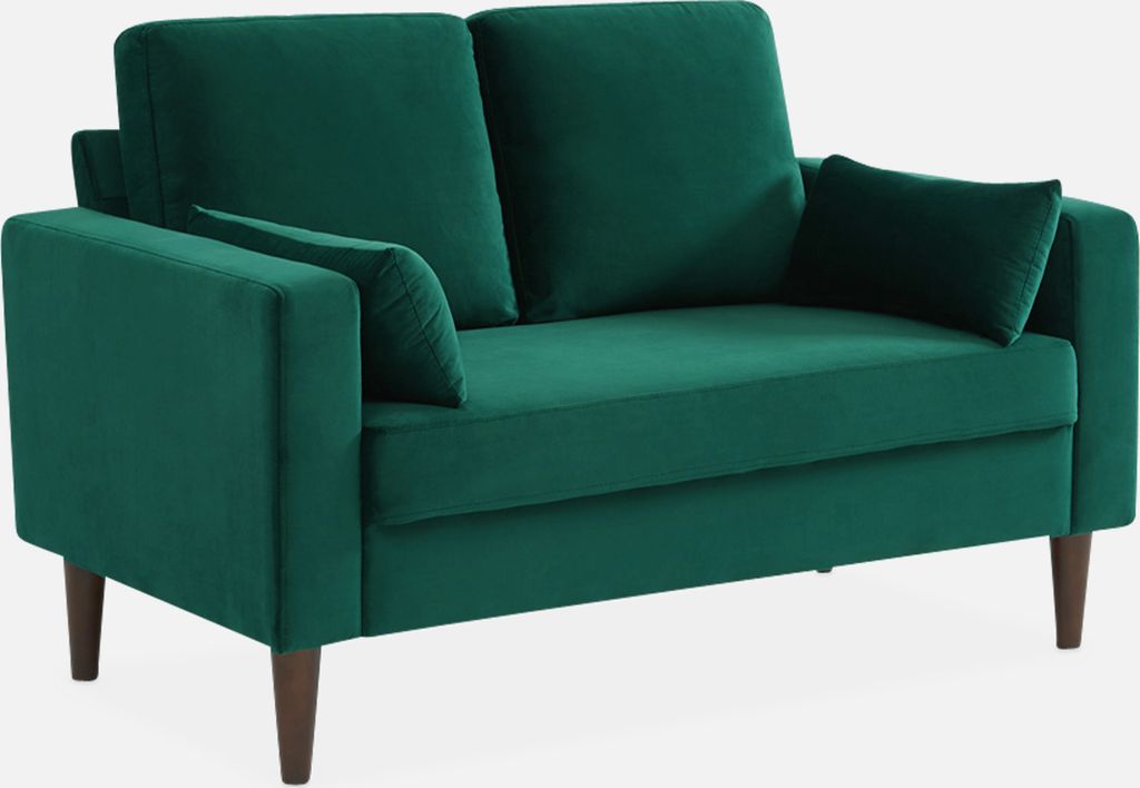 A green velvet loveseat on a white background.