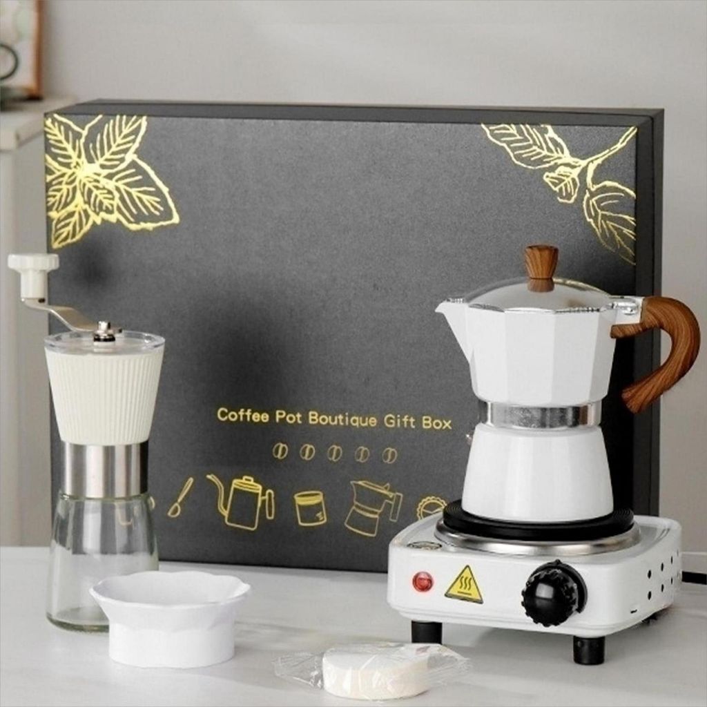 A coffee making set displayed on a table, with a gift box in the background.