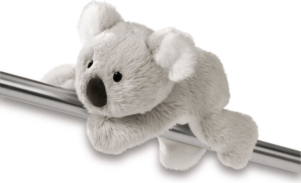 A plush koala toy is clinging to a metal bar.