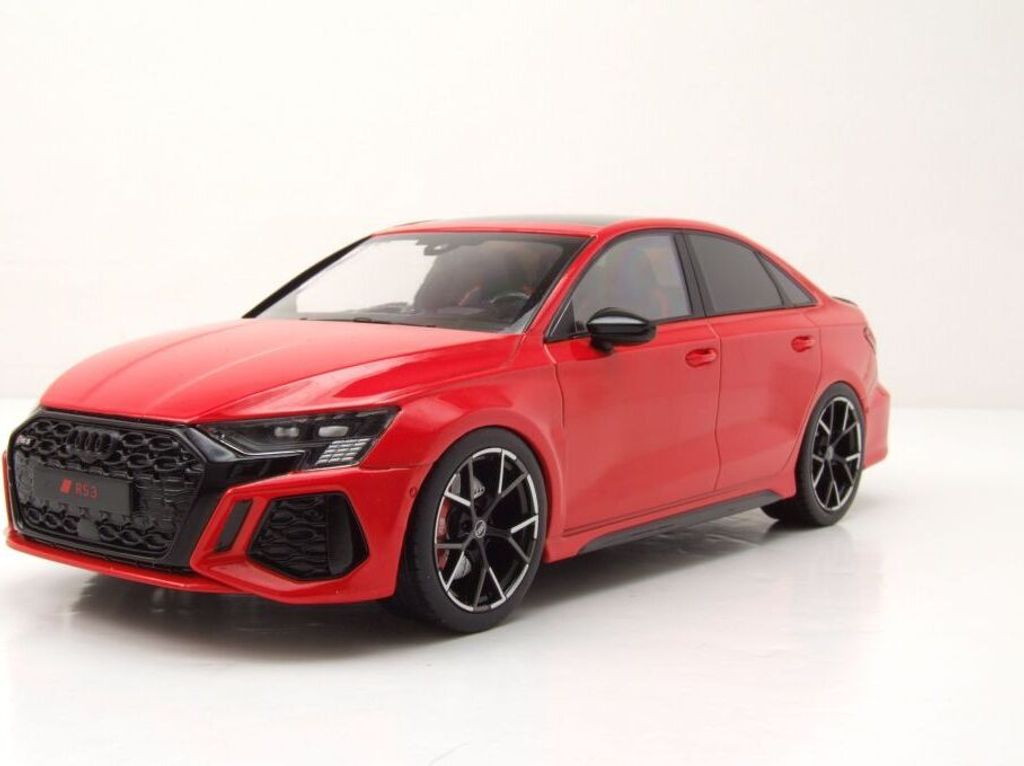 A red Audi RS3 model car is displayed on a white background.
