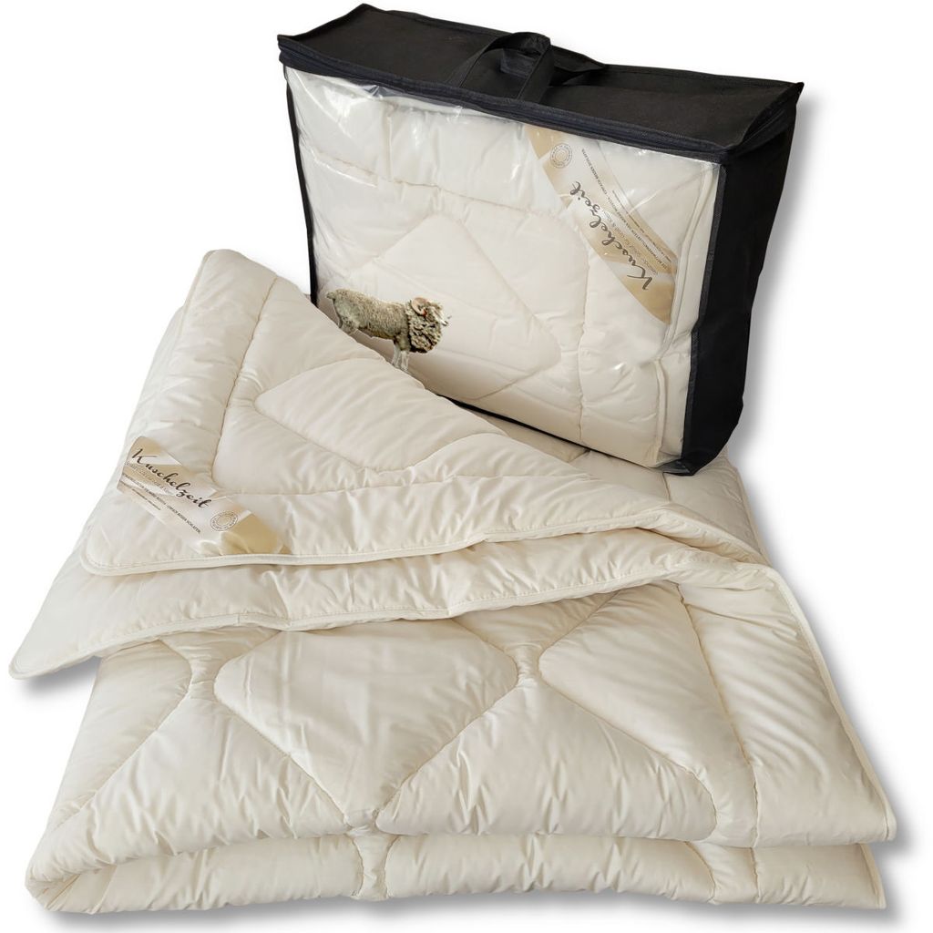 A folded blanket and its storage bag are displayed against a white background.