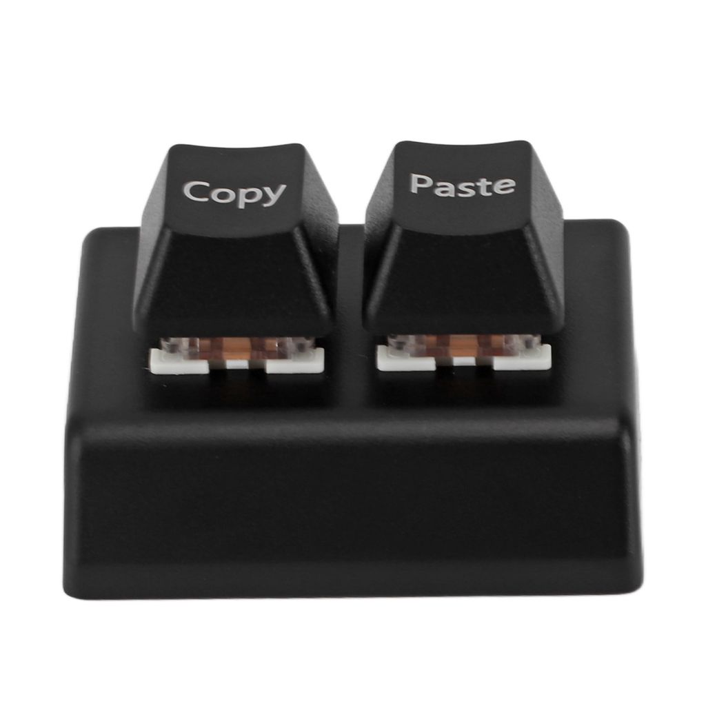 A close-up studio shot of a black programmable keyboard with two keys labeled 'Copy' and 'Paste'.