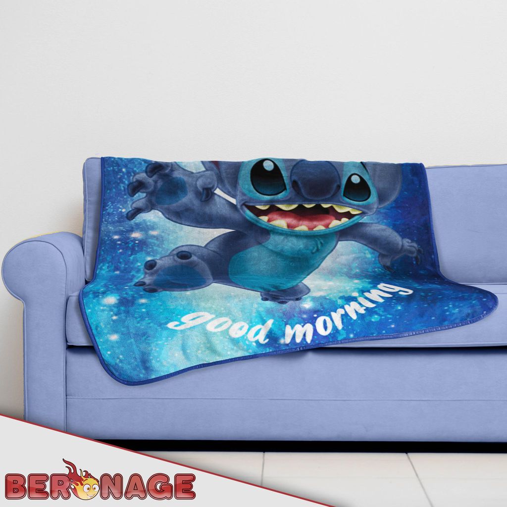 A blanket with a Lilo & Stitch design is draped over a sofa.