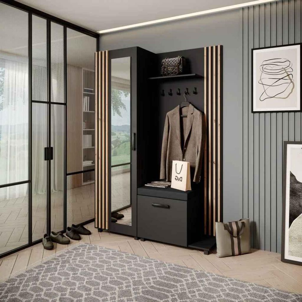 A modern entryway with a black and oak artisan wardrobe set, featuring a mirror, coat hooks, and storage. The room also includes a glass partition, a rug, and artwork on the wall.