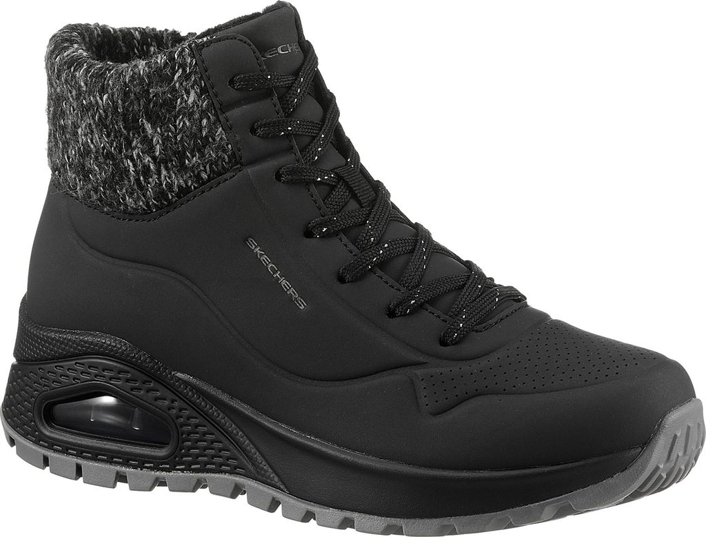 A studio shot of a black Skechers boot.
